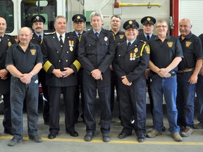 Portage Emergency Services handed out Fire Services Exemplary Service Medals to firefighters who have served at least 20 years Thursday. Pictured left to right are deputy fire chief Dave Holmes, Bob Wood, Daren Van Den Bussche, fire chief Phil Carpenter (30 years), Capt. Dave Sproat, Wendell Williams (30 years), Dean Arndt, Capt. George Kerr (30 years), Capt. Todd McKinnon, Ted Jordan, Dave Green (30 years) and Doug Henderson. (CLARISE KLASSEN/PORTAGE DAILY GRAPHIC/QMI AGENCY)