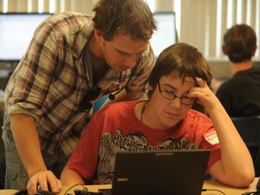 Consultant D.J. Cunningham helps Rosedale student Matthew Chartrand during an assistive technology camp held in Sarnia Friday. Cunningham shared his own story of overcoming a learning disability with participating students from the Lambton Kent District School Board. (BARBARA SIMPSON, The Observer)