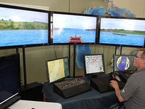 Peter Buell sets up the Great Lakes freighter navigation simulator that is at the Marine Museum of the Great Lakes this weekend. Members of the public are invited to try their hand at driving a lake freighter.
Michael Lea The Whig-Standard