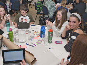 Boston Public School students (from left) Mary Freeman, Olivia Collver and Ben Hoerdt, and Agnes Hodge School students Emery Box and Arden Leschuk utilize cell phones, tablets and laptops on Friday, May 17 at the Student Forum on 21st Century Educational Technology, held at the Brant Park Inn in Brantford. (BRIAN THOMPSON Brantford Expositor)