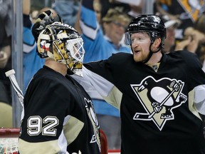 Pittsburgh Penguins goaltender Tomas Vokoun is congratulated by teammate Paul Martin after defeating the Ottawa Senators 4-3 during NHL Eastern Conference Semifinal playoff hockey action at the Consol Energy Center in Pittsburgh, Pennsylvania on Friday May 17 ,2013. Errol McGihon/Ottawa Sun/QMI Agency