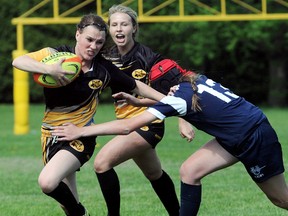 Blenheim Bobcats' Hailey Newham, left, tries to elude Ursuline Lancers' Avery Hughson while Bobcats' Maggie Clendenning yells during the first half in the Kent girls rugby final Friday at Blenheim. (MARK MALONE/The Daily News)