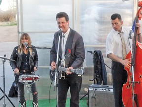 Toronto’s Alistair Christl, centre, performed some rockabilly music with Dani Nash and Brian Templeton in Vulcan on Friday night at the Market Street greenhouse.
