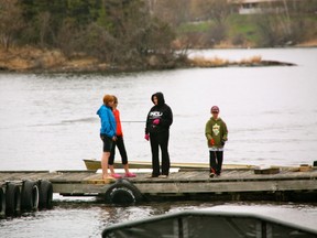A group of children fish on the Harbourfront during a rainy opening weekend.