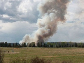 The plume of smoke from a wildfire near Groat Creek that started in the afternoon of May 18 was clearly visible along Highway 32 South. Wooldands County Peace Officers asked people not to park on the side of the highway and spectate.