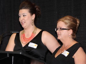 Julie Dolmont, left, addresses the crowd at MACOY’s 20th anniversary celebration Saturday evening.