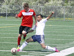 Greater Sudbury Impact's Cam Lapienis, left, battles for the ball with Ajax United's Kainan Griffith during CSL Cup opening-round soccer action at James Jerome Sports Complex on Sunday. Greater Sudbury won 2-0. Ben Leeson/The Sudbury Star/QMI Agency