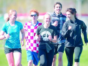 Superior Heights students Marissa Lobert, James Mesich, Lynnea Lobert, Aaron Mohammadi and coach Lorri Purnis do laps around the John Rhodes Community Centre track in preparation for the annual high school track meet starting this Wednesday. The two-day track and field meet is attended by students from all school boards.