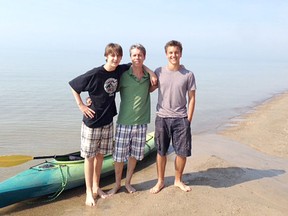 Bruce Beach cottagers Zachary Wigle, 14, father Jeff Wigle, 49, and family friend Jack De Ferrari, 14, took to the Lake Huron waters over the Victoria Day long weekend to rescue a young deer that was startled and swam out in deep waters off shore. The trio corralled the animal back to the sandy beach where it was able to escape back into the bush. (CHRISTINE MULKINS/SUBMITTED)
