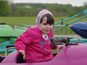 Lexi Wood, 3, takes her first ride at an amusement park during Thamesford's Calithumpian on Saturday May 18, 2013. (File photo)