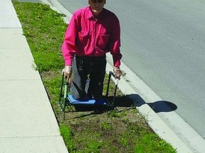 David Webster, a resident of Brock St., says weeds along the street are flourishing in the warm sunshine. Residents are blaming a town sub-contractor on shoddy work in replanting grass on the town-owned strip between the sidewalk and street following the replacement of a water main in 2011.        Wayne Lowrie-Gananoque Reporter