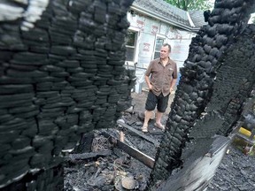 Brian Dietrich stands amidst the damage after fire gutted the family garage and back porch. (SCOTT WISHART, The Beacon Herald)