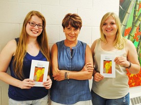 Amber Van Wort photo
From left, student BillySue Johnston, teacher Ardith Racey and Drew Feuerherdt hold their Turning Points Essay programs.