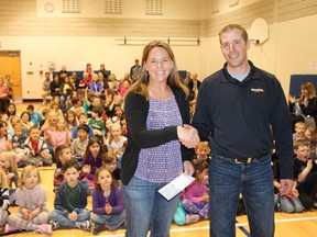 Lydia Steffen (left) with the Brunswick School Community Council accepted a donation from Doran Pronych with Richardson Pioneer.