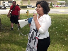 Vanessa Gray speaks to a group of protesters outside a Bitumen conference at the Guildwood Inn Tuesday. She was attending the conference and went on stage during Frank McKenna's speech holding a banner that said "You are killing my generation." She was asked to leave the conference. PAUL MORDEN/THE OBSERVER/QMI AGENCY