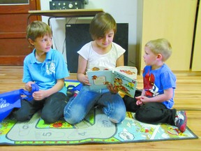 Samantha Dawn, centre, a Grade 2 Elmer Elson Elementary School student in the class of teacher Darla Masterson, reads to Seth Chupak, left, another Grade 2 student, and Aiden Milburn of the Mayerthorpe Play Group on Wednesday, May 15. The school’s two Grade 2 classes visited Affordable Fashions and More the previous seek to buy books which they used to read and then gave to playgroup children. It is an annual event which allows the Grade 2s to meet future students so the playgroup children will be more comfortable in school