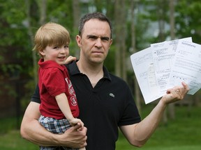 Paul Ferreira holds his three-year-old son Martin and a series of bills that he has received from a Florida hospital since the boy received an hour?s treatment for bronchitis two months ago. Although insured, Ferreira finds the string bills confusing and frustrating. DEREK RUTTAN The London Free Press