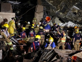 Oklahoma National Guard soldiers and rescue workers dig through the rubble of Plaza Tower Elementary school May 21, 2013 after a devastating tornado ripped through Moore, Oklahoma, May 20. The 2-mile (3-km) wide tornado was originally feared to have killed up to 91 people and injured more than 200.   
(REUTERS/Sgt. 1st Class Kendall James/Oklahoma National Guard)