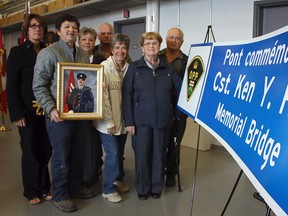 An emotional ceremony at the South Porcupine OPP detachment was held to commemorate Const. Ken Roy and acknowledge the bridge which has been named in his honour. Roy was a local policeman killed in a car accident on May 23, 1995. Members of the Roy family were on hand to pose with one of the signs that will mark the Const. Ken Y. Roy Memorial Bridge, located near Timmins on Highway 144, six kilometres south of Highway 101.