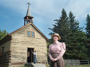 Stephanie McLachlan, program coordinator for Historic Dunvegan Provincial Park, poses in front of the St. Charles Mission Church.