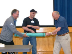 Former E.E. Oliver principal Greg Woronuk, Jerry Graham, and present E.E. Oliver principal Gel Mackey opened up the time capsule and took the contents out for examination. Graham was a Grade Four student at E.E. Oliver when the time capsule was created and wrote then he had learned about “Judo, getting into trouble and Nintendo” that year. Chris Eakin/Fairview Post