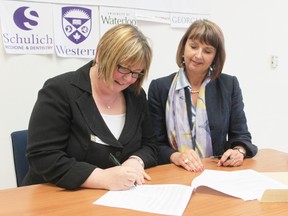 Gateway Rural Health Research Institute president Gwen Devereaux looks on as Dr. Margaret Steele, vice dean of hospital and interfaculty relations at Western University signs a memorandum of understanding between the two organizations last Thursday in Seaforth.
