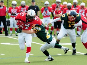 Team South All-Stars running back Dilyaad Bahia, of the Calgary Wildcats, is wrapped up by a Team North All-Stars linebacker during the first quarter of the 2013 Bantam Bowl at Foote Field in Edmonton, AB, on Monday, May 20, 2013. Team South won the game 19-8. TREVOR ROBB/QMI AGENCY