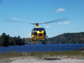 The Ministry of Natural Resources helicopter on its way to restock one of the local lakes with the young trout. The round trip took an amazing 15 minutes from take off to relanding. Photo by Helen Morley/Mid-North Monitor/QMI Agency