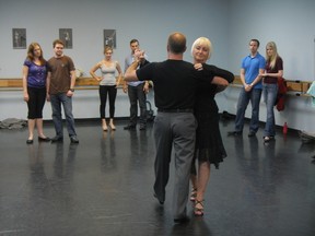 Dance instructors Claude Marc Forest and Linda Thomson demonstrate a step as members of the class observe.