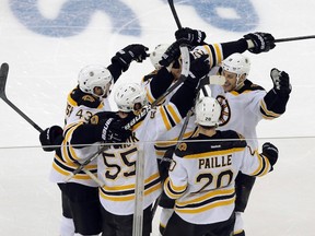 Boston Bruins players celebrate a goal by Johnny Boychuk (55) against the New York Rangers in the third period of Game 3 of their NHL Eastern Conference semi-final playoff hockey series in New York May 21, 2013. (REUTERS/Ray Stubblebine)