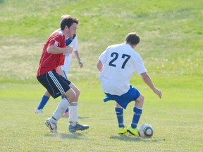 Contributed Photo
Coleson Jeffries confounds an Oakridge player with dekes while player Jeremy Allen looks on during the Simcoe Crew's game Sunday. The game ended in a 2-2 tie.