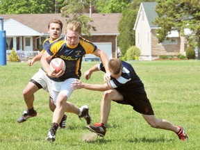 EDDIE CHAU Simcoe Reformer
Delhi Raiders' Mason Ryan pie-faces a member of the Simcoe Sabres during a NSSAA boys rugby semifinal game Wednesday in Delhi. The Raiders won 24-0.