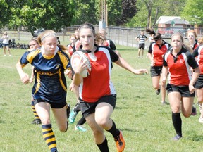 MONTE SONNENBERG Simcoe Reformer
Beth Girard of the Waterford Wolves does an end-run around Delhi defenders during Wednesday's semi-final win over the Raiders. The lady Wolves advanced to Friday's county final against the Holy Trinity Titans on the strength of a 35-5 win.