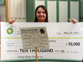 Grade 12 Westwood student Diamond Cisna holds a $10,000 cheque from BP Canada for a A+ for Energy grant behind the Green Initiative group’s indoor herb garden, following a presentation by the oil giant Wednesday afternoon. Amanda Richardson/Today staff