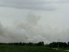 Smoke billows above the trees from an out-of-control fire that prompted the evacuation of the Hamlet of Lindale on Wednesday afternoon.