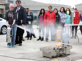 O’Gorman Intermediate School student Aleesha Roy successfully puts out her first fire with a little help from Timmins Fire Department prevention officer Rock Rice. O’Gorman High School’s Justice Career Fair was held on Wednesday, offering students a glimpse into different potential career options.