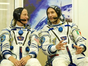 European Space Agency astronaut Luca Parmitano (R) and NASA astronaut Karen Nyberg chat during training at the Baikonur cosmodrome May 17, 2013. REUTERS/Sergei Remezov