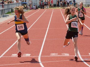 Delhi District Secondary School's Alexa Leitch outreaches Alex Girardi from Brantford's St. John's College during a midget girls 400 metre heat Wednesday at Day 1 of the Central Western Ontario Secondary School Association track and field championships at Jacob Hespeler Secondary School in Cambridge. DARRYL G. SMART QMI Agency
