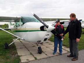 Liam and Wayne Fraser of Embro, look over an airplane Saturday during the first Fly n' Buy at the Tillsonburg Regional Airport. The two joined approximately 150 pilots and airplane enthusiasts for the event.

KRISTINE JEAN/TILLSONBURG NEWS/QMI AGENCY