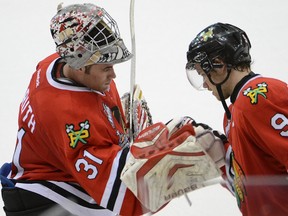 Portland Winterhawks goaltender Mac Carruth and Chase De Leo celebrate after a 4-2 victory over the Saskatoon Blades during the Memorial Cup in Saskatoon May 22, 2013. (Al Charest/Calgary Sun/QMI Agency)