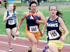 Rayne Kellier, right, of CKSS pulls away from Massey's Molly Ricciardi and Ursuline's Alexandra Badder to win their heat in the midget girls' 4x100-metre relay on the first day of the SWOSSAA track and field championships Wednesday in Sarnia. The Golden Hawks finished sixth overall, missing a berth at the OFSAA West Regional meet by one spot. However, Kellier qualified individually by placing second in the high jump and fifth in the 400 metres. (PAUL OWEN/QMI Agency)