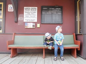 Micah, left, and older brother David eagerly await a ride on the train at the Alberta Central Railway Museum May 19.