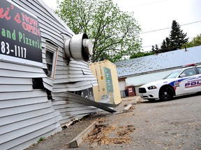 The wall of Contini's Eatery and Pizzeria in Dresden, On., was knocked in about two feet after a man driving a Chevy Suburban hit the accelerator instead of the brake causing about $40,000 in damages Thursday May 23, 2013.  (DIANA MARTIN, Chatham Daily News)