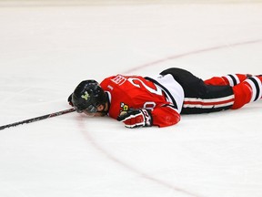 Portland Winterhawks' Taylor Leier lays on the ice motionless after being hit by Saskatoon Blades' Dalton Thrower on May 22, 2013. (REUTERS)