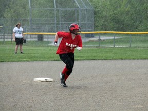 Paris Panther Skylar Wright takes off for third base in the bottom of the fourth inning of the last game of the regular season. Extremely heavy rain ended the game moments later, giving the Panthers a win over the St. John's Green Eagles. MICHAEL PEELING/The Paris Star/QMI Agency