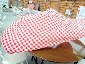 Robert Hargrave and Helen Dowd add a splash of colour to tables at the new Milverton Agri Centre Thursday in preparation for the Denim and Rhinestones dinner and auction being held tonight, Friday, with doors opening at 6 p.m. (SCOTT WISHART The Beacon Herald)