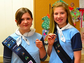 Emily McDonald, 12, and Jenna Russell, 11, both Girl Guides of Warkworth proudly show off their new Lady Baden-Powell pins awarded to them during a special end-of-year ceremony at St. Andrew’s Presbyterian Church on May 13. The award is the highest achievement a Guider can earn.