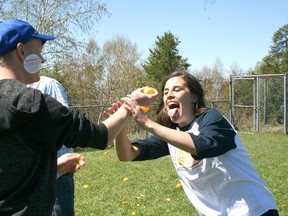 Jodi Melillo, right, tries to eat an orange out of Matthew Smith’s hand during an orange eating contest for the Tan-Free Grad Campaign. Students at Beaver Brae led by Andrea Johnson have been campaigning against tanning for prom or graduation because of the risk of skin cancer.
GRACE PROTOPAPAS/Daily Miner and News