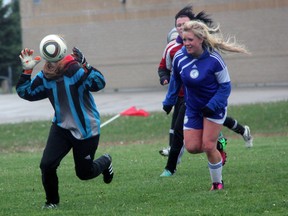 Northern Vikings goalkeeper Jessi Kozachuk, left, corrals the ball ahead of St. Chris Cyclones attacker Jenelle Labadie, right, during the LSSAA senior girls soccer final Thursday May 23, 2013 at St. Chris in Sarnia, Ont. PAUL OWEN/THE OBSERVER/QMI AGENCY