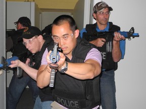 Joe Giroux (left), Michael Ling and Tony Henrique take part in Tac-4-a-Day at the Brantford police station. Ten participants paid $500 each for a day of police training to raise funds for the Brant United Way. (MICHELLE RUBY, The Expositor)